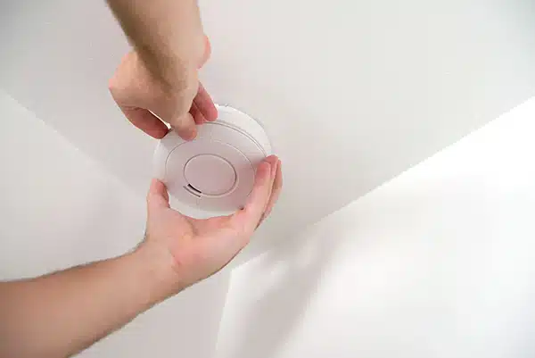 A smoke alarm on a ceiling.