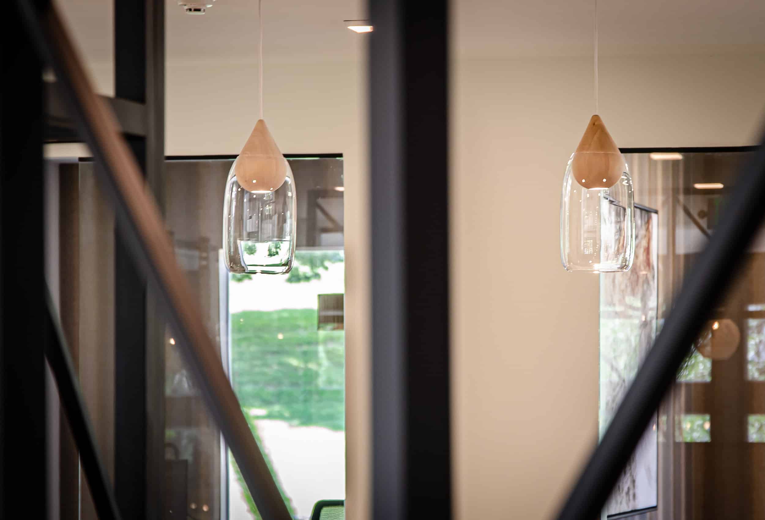 glass pendant lights with a reflection on glass door — Professional Power Colorado
